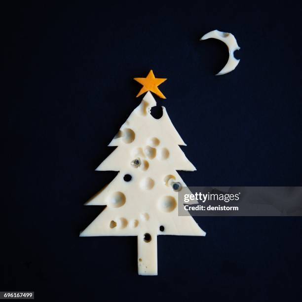 conceptual christmas tree made of cheese with holes - imitation cheese stock pictures, royalty-free photos & images