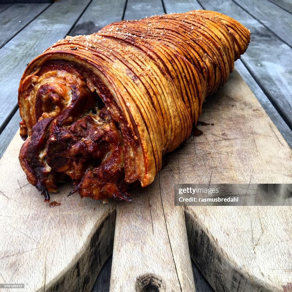 Roasted porchetta on a chopping board