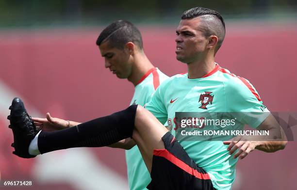 Portugal national team defender Pepe and forward Cristiano Ronaldo take part in a training session in Kazan on June 15 as part of the team's...