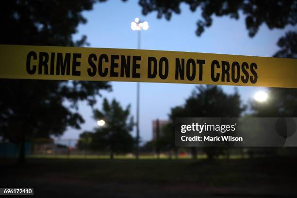 Crime scene tape surrounds the Eugene Simpson Field, the site where a gunman opened fire June 15, 2017 in Alexandria, Virginia. Multiple injuries...