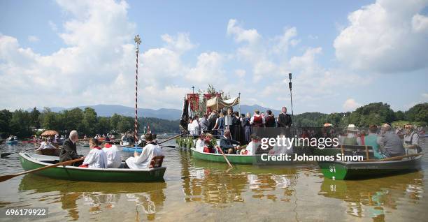 Participants dressed in traditional Bavarian folk outfits cross in boats the Staffelsee Lake in the annual Corpus Christi procession on June 15, 2017...