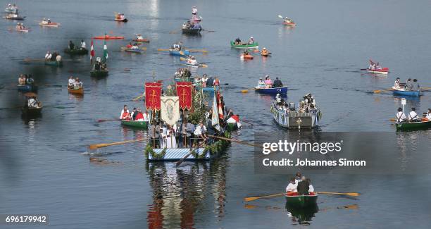 Participants dressed in traditional Bavarian folk outfits cross in boats the Staffelsee Lake in the annual Corpus Christi procession on June 15, 2017...