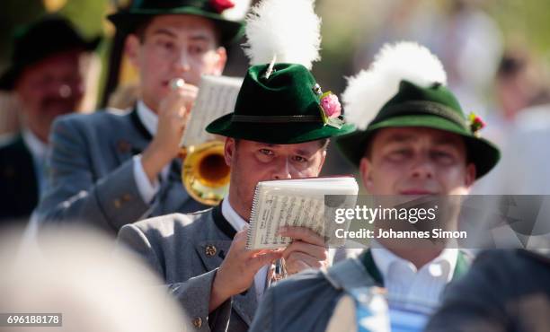 Participants dressed in traditional Bavarian folk outfitsarrive for to board boats to cross Staffelsee Lake in the annual Corpus Christi procession...