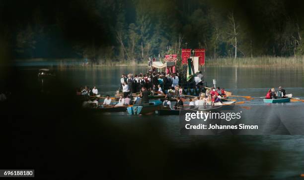 Participants dressed in traditional Bavarian folk outfits cross in boats the Staffelsee Lake in the annual Corpus Christi procession on June 15, 2017...