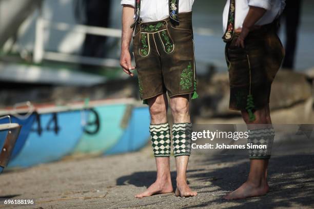 Participants dressed in traditional Bavarian folk outfits arrive for to board boats to cross Staffelsee Lake in the annual Corpus Christi procession...