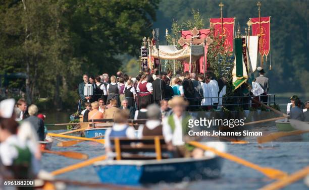 Participants dressed in traditional Bavarian folk outfits cross in boats the Staffelsee Lake in the annual Corpus Christi procession on June 15, 2017...