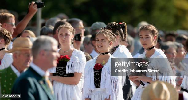 Participants dressed in traditional Bavarian folk outfitsarrive for to board boats to cross Staffelsee Lake in the annual Corpus Christi procession...
