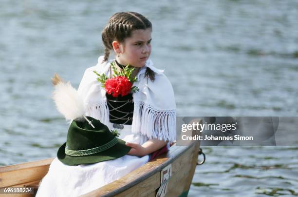 Participants dressed in traditional Bavarian folk outfits cross in boats the Staffelsee Lake in the annual Corpus Christi procession on June 15, 2017...