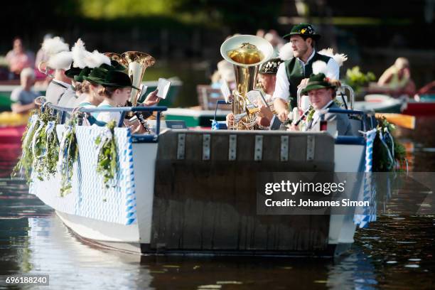 Participants dressed in traditional Bavarian folk outfits cross in boats the Staffelsee Lake in the annual Corpus Christi procession on June 15, 2017...