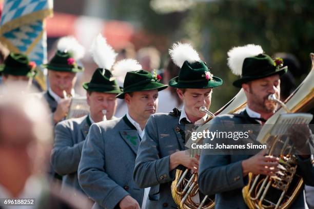 Participants dressed in traditional Bavarian folk outfitsarrive for to board boats to cross Staffelsee Lake in the annual Corpus Christi procession...