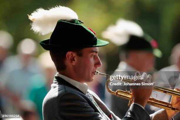 Participants dressed in traditional Bavarian folk outfitsarrive for to board boats to cross Staffelsee Lake in the annual Corpus Christi procession...