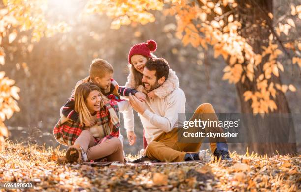 famille ludique s’amuser dans la journée d’automne au parc. - autumn photos et images de collection