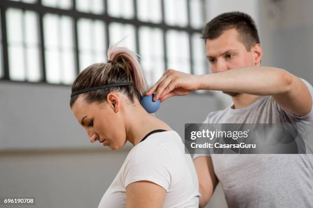 alternative therapy with stress ball for shoulder relaxation - shoulder massage stock pictures, royalty-free photos & images