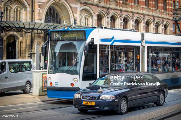 The Volvo S80 royal car of Princess Beatrix of The Netherlands passes a tram before her arrival the Royal Palace for the annual palace symposium on...