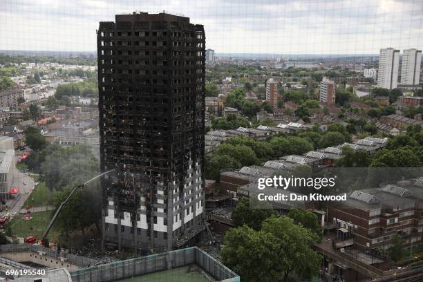 Hose continues to douse the fire at Grenfell Tower on June 15, 2017 in London, England. At least 17 people have been confirmed dead and dozens...