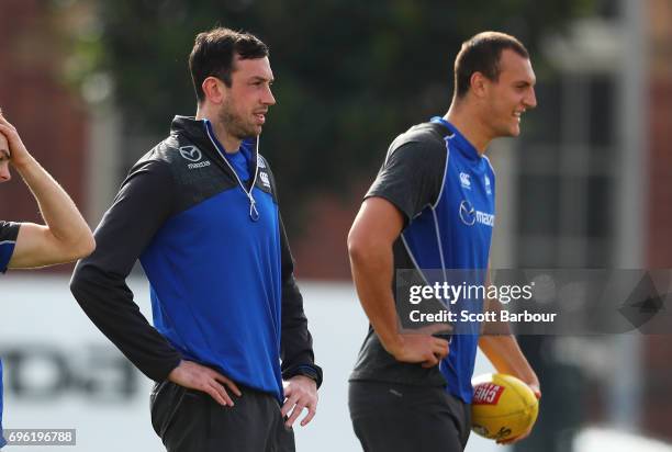 Todd Goldstein and Braydon Preuss of the Kangaroos look on during a North Melbourne Kangaroos AFL training session at Arden Street Ground on June 15,...
