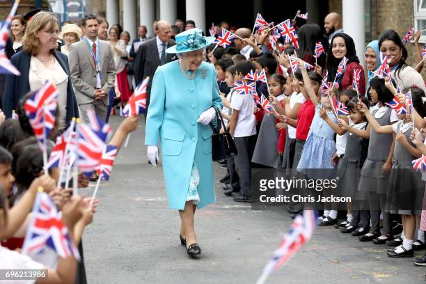 Queen Elizabeth II and Prince Philip, Duke of Edinburgh leave Mayflower Primary School during an official visit to Tower Hamlets on June 15, 2017 in...