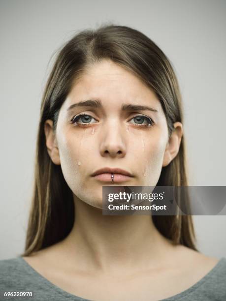 real young woman crying studio portrait - teardrop imagens e fotografias de stock