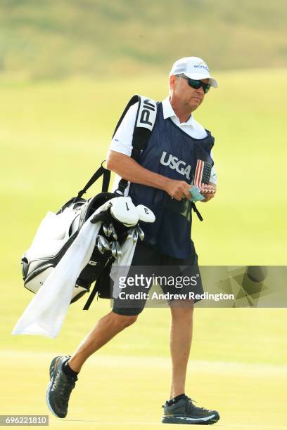Davis Love III of the United States caddies for son Davis Love IV during the first round of the 2017 U.S. Open at Erin Hills on June 15, 2017 in...