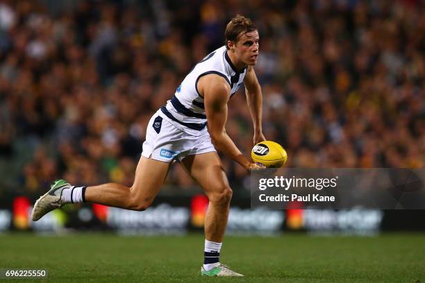 Jake Kolodjashnij of the Cats handballs during the round 13 AFL match between the West Coast Eagles and the Geelong Cats at Domain Stadium on June...