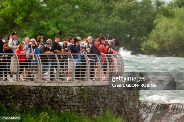 Crowds gather at Terrapin Point on Goat Island in Niagara Falls, New York to watch Aerialist Erendira Wallenda hang beneath a helicopter during a...