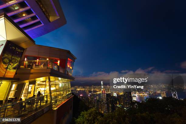 peak tower of victoria peak and the harbor evening scene, hong kong - long exposure restaurant stock pictures, royalty-free photos & images