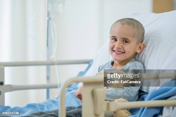 happy little boy battling with cancer - childhood cancer stock pictures, royalty-free photos & images