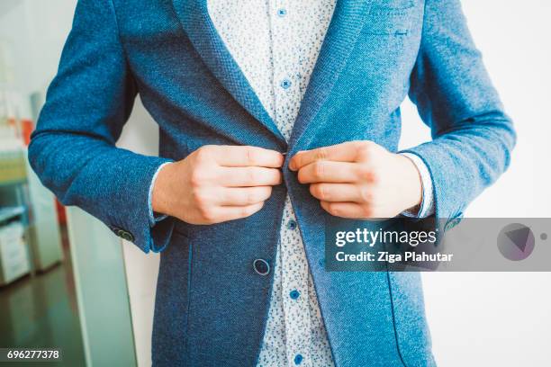 man wearing suit - adjusting suit stock pictures, royalty-free photos & images