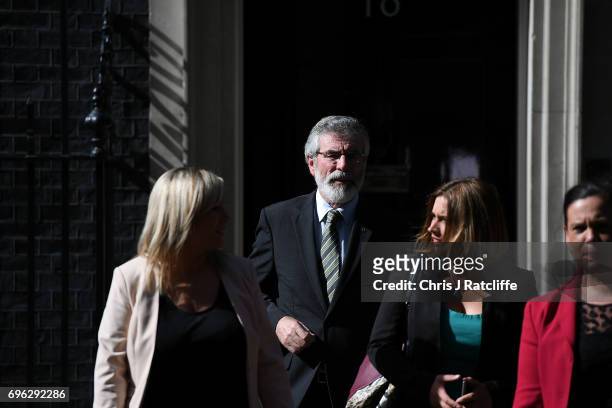 Gerry Adams, President of Sinn Féin and Michelle O'Neill, leader of Sinn Féin walk with colleagues as they prepare to speak to the media outside 10...