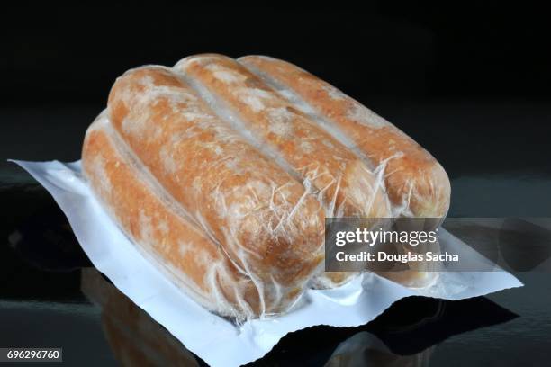 polish sausages sealed in a vacuum sealed container - frozen meat stock pictures, royalty-free photos & images