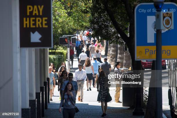 Pedestrians walk in the downtown area of Sacramento, California, U.S., on Tuesday, June 6, 2017. As the cost of daily life tests the bounds of...