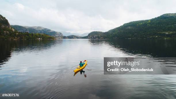 aerial view of woman kayaking on the lake in mountains - northpark stock pictures, royalty-free photos & images