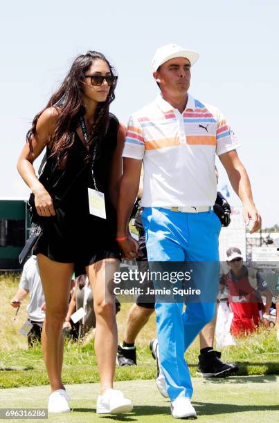 Allison Stokke and Rickie Fowler of the United States walk off the course during the first round of the 2017 U.S. Open at Erin Hills on June 15, 2017...