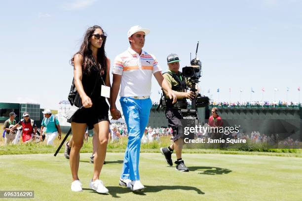 Allison Stokke and Rickie Fowler of the United States walk off the course during the first round of the 2017 U.S. Open at Erin Hills on June 15, 2017...