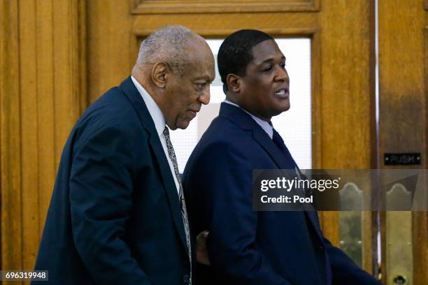 Bill Cosby leaves with aide Andrew Wyatt on the fourth day of jury deliberations in Cosby's sexual assault trial at the Montgomery County Courthouse...