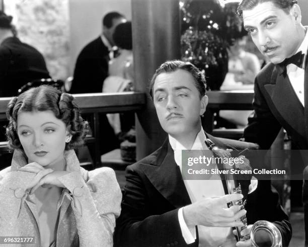 From left to right, actors Myrna Loy as Nora Charles, William Powell as Nick Charles and Joseph Calleia as 'Dancer' in the sequel 'After the Thin...