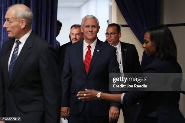 Vice President Mike Pence arrives for a photo opportunity with U.S. Secretary of Homeland Security John F. Kelly at the Conference on Prosperity and...