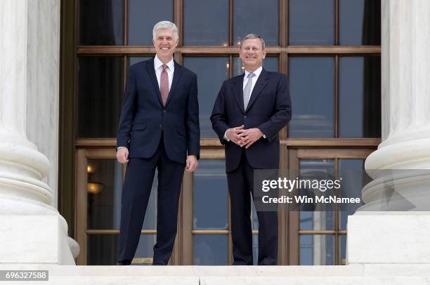 Supreme Court Justice Neil Gorsuch talks with Chief Justice John Roberts on the steps of the Supreme Court following his official investiture at the...