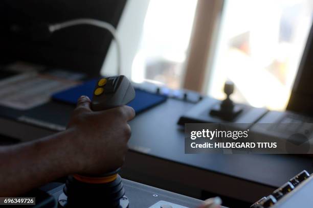 Dion Ankonga, the seabed tool operator, hands a joystick aboard the SS Nujoma, a vessel built out of partnership between mining giant De Beers and...