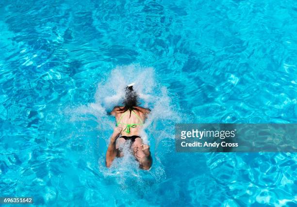 Kelly Stone hits the water hard to win the women's division of the 21st annual Belly Flop Splashdown competition at Water World June 15, 2017 in...