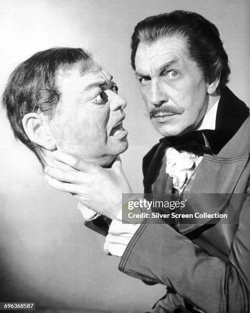 American actor Vincent Price holding the head of co-star Peter Lorre in a publicity still for the film 'Tales of Terror', 1962. The film is based on...