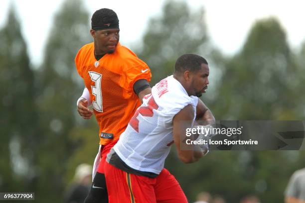 Quarterback Jamies Winston hands the ball off to runningback Doug Martin during the Tampa Bay Buccaneers Minicamp on June 14, 2017 at One Buccaneer...