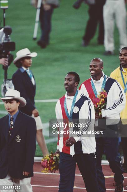 American track athlete Michael Johnson pictured leaving the medal podium after finishing in first place for the United States team to win the gold...