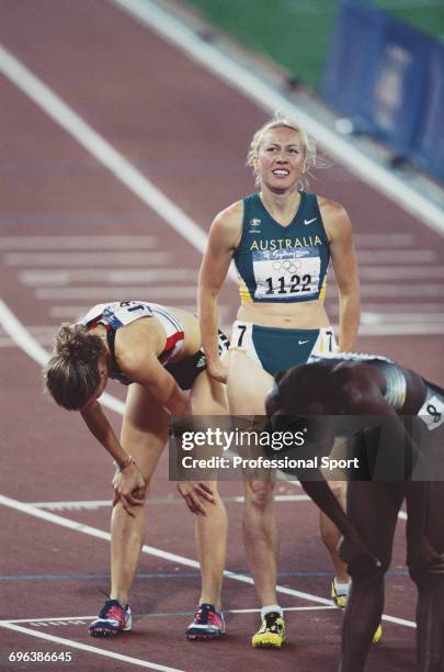 Australian track athlete Tamsyn Lewis grimaces after finishing in fourth place in heat 1 of the semi-finals and failing to qualify for the final of...