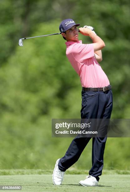 Poston of the United States plays his tee shot on the par 3, 16th hole during the first round of the 117th US Open Championship at Erin Hills on June...