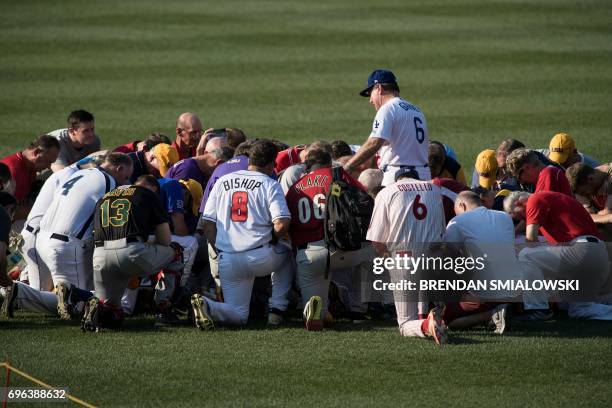 Members of the Republican team say a prayer before the Congressional Baseball Game between Democrats and Republicans at Nationals Stadium June 15,...