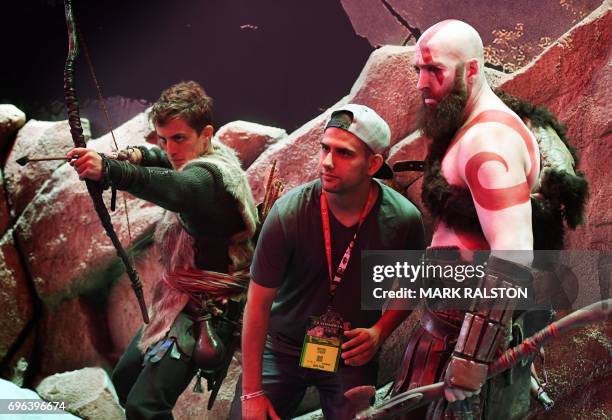 Gamer poses with characters from the 'Uncharted: The Lost Legacy' game at the Los Angeles Convention center on day three of E3 2017, the three day...