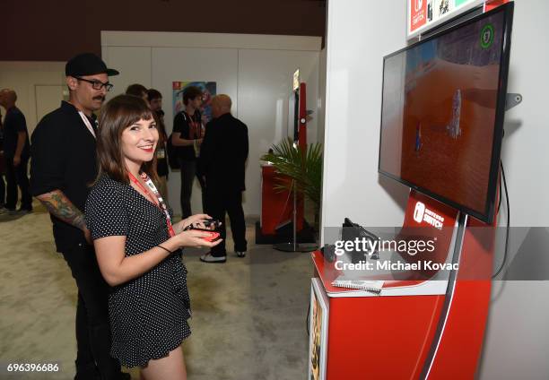 Actress Cassandra Morris plays Super Mario Odyssey at the Nintendo booth at the 2017 E3 Gaming Convention at Los Angeles Convention Center on June...