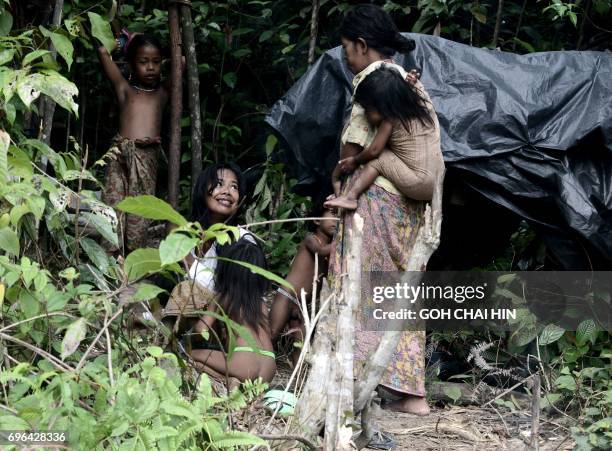 This photo taken on May 19, 2017 shows women from the Indonesian "Orang Rimba" tribe -- whose name translates as "jungle people", who consider being...