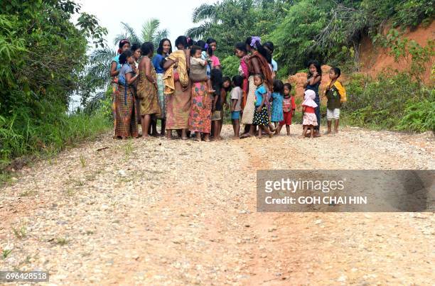 This photo taken on May 19, 2017 shows women from the Indonesian "Orang Rimba" tribe -- whose name translates as "jungle people", who consider being...